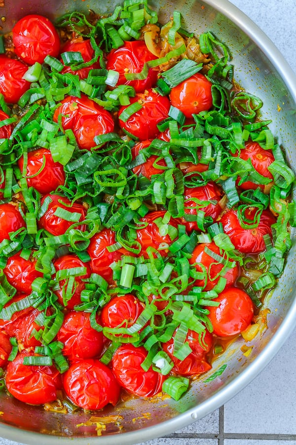 Green onions added in cooking cherry tomatoes