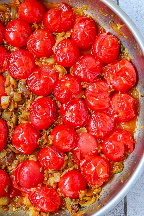 Pressed cooking cherry tomatoes in a pan
