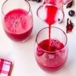 Q, pouring grapefruit-hibiscus juice in glasses