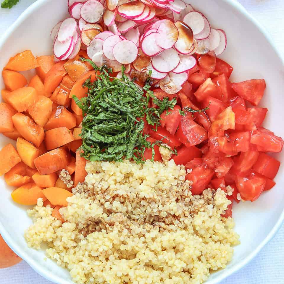 Diced ingredients for quinoa apricot salad in a bowl