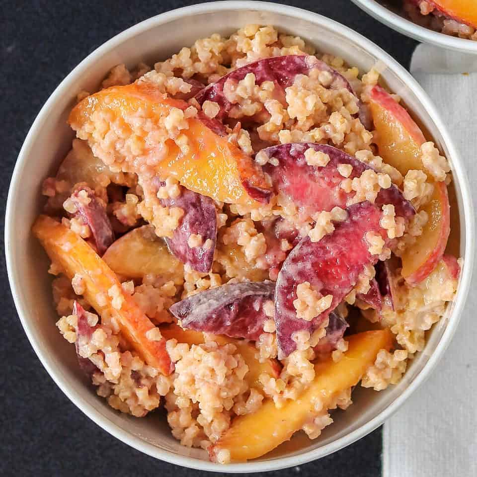 a bowl of ginger millet breakfast with peaches