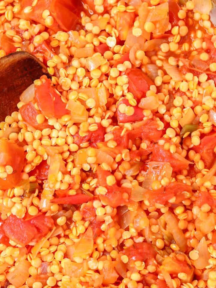 Red lentils, tomatoes and onions cooking in a pan