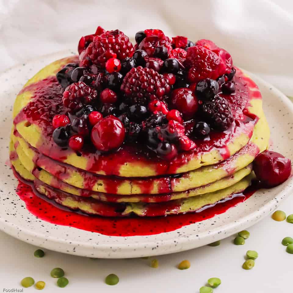 Split pea oatmeal pancakes served with cooked red fruits
