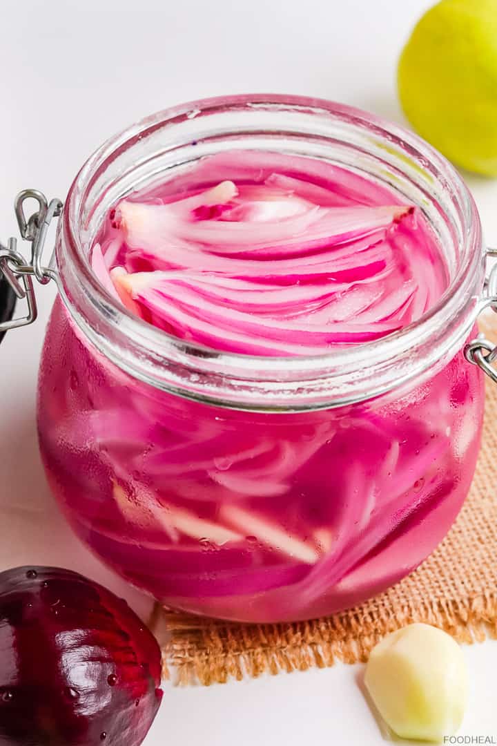 Red onions pickled with garlic in a jar