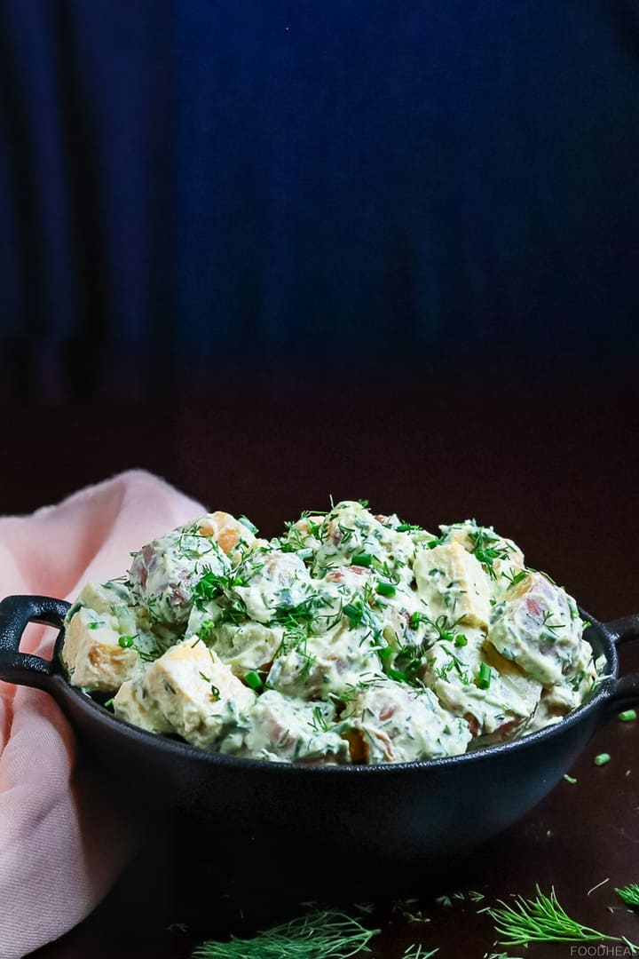Vegan potato salad garnished with chives & dill
