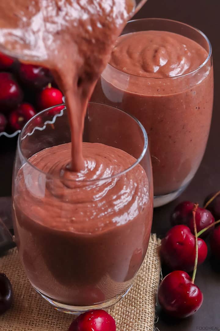 pouring cherry chocolate smoothie into a glass