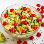 a bowl of cucumber quinoa salad with cherry tomatoes