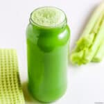 Celery juice in a bottle with celery stalk
